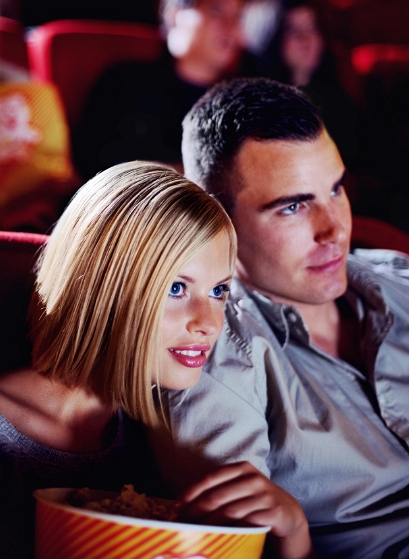 local dating header image of guy and girl at movie with popcorn