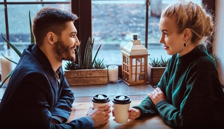 building attraction header image man and woman talking over coffee