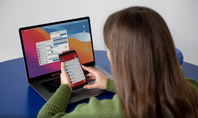 personal ads header image of woman looking at personal ads on phone