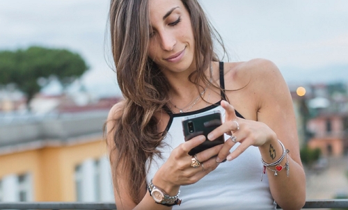 dating app profiles woman holding cell phone