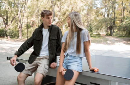 fun activities guy and girl playing ping pong